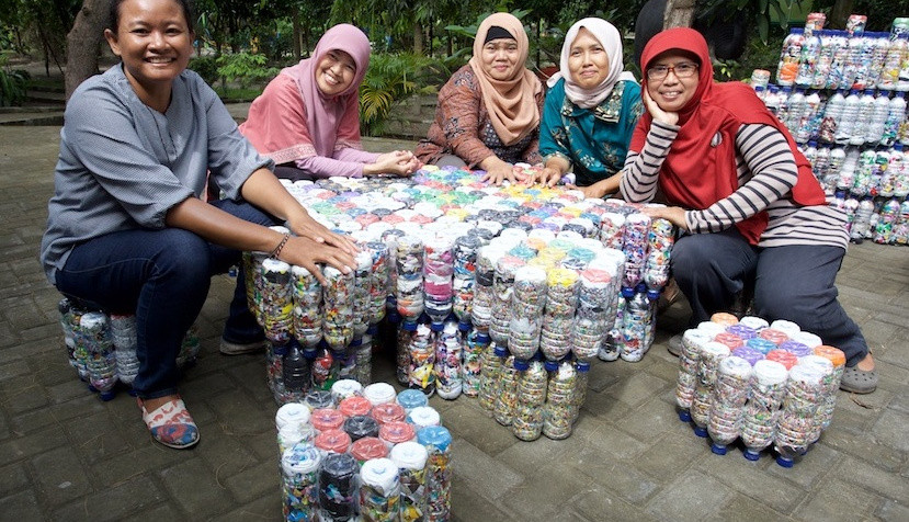 GEA trainers sitting at a table with eco brick milstein modules made from plastic